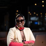 Confident businesswoman with laptop in an elegant indoor office setting.
